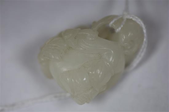 A Chinese white jade two boys carving and a celadon jade lion-dog, H. 3.7cm and 4.4cm